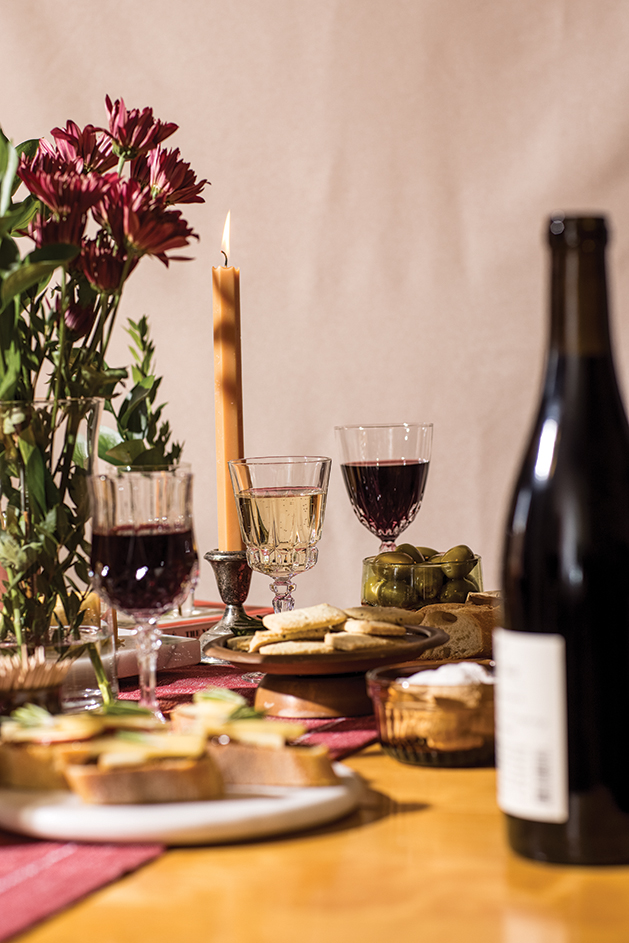 Table setting with wine glasses and bottle of wine.
