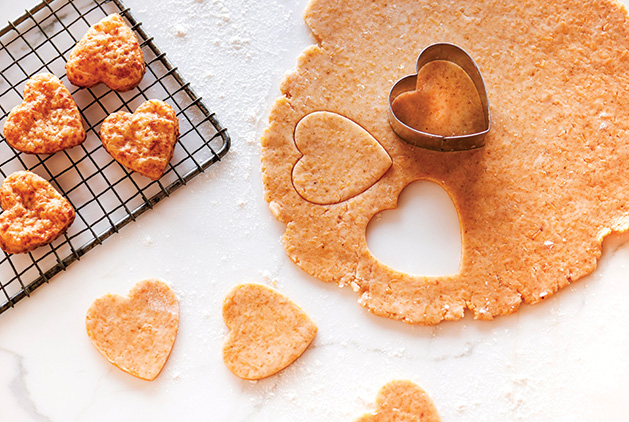 Heart-shaped cookies cut out of a piece of dough