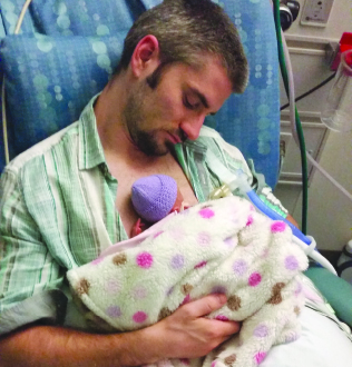 Mike holding Lana in the hospital