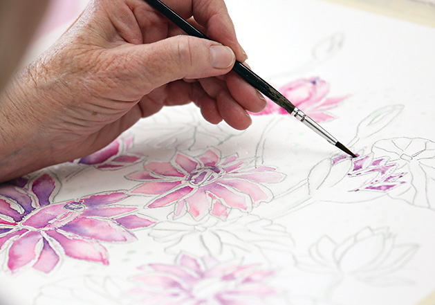 Older adult creating a watercolor painting.