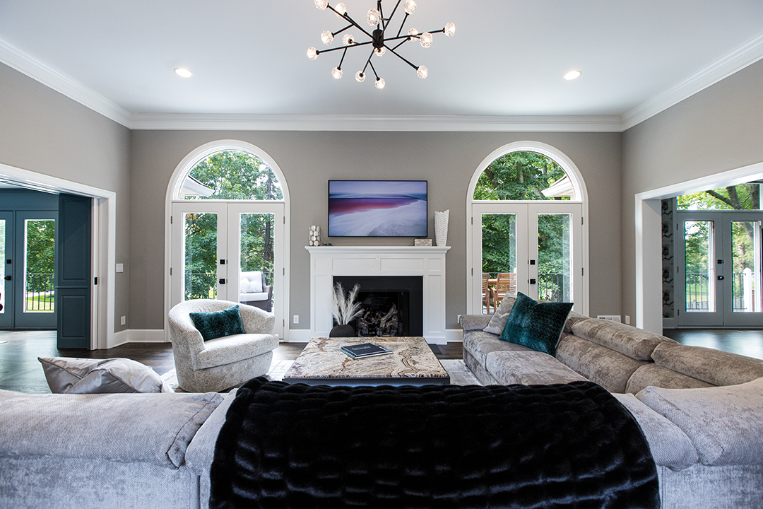 This newly renovated living room is an elegant and bright environment that leads into the den seen above. Photo: Chris Emeott