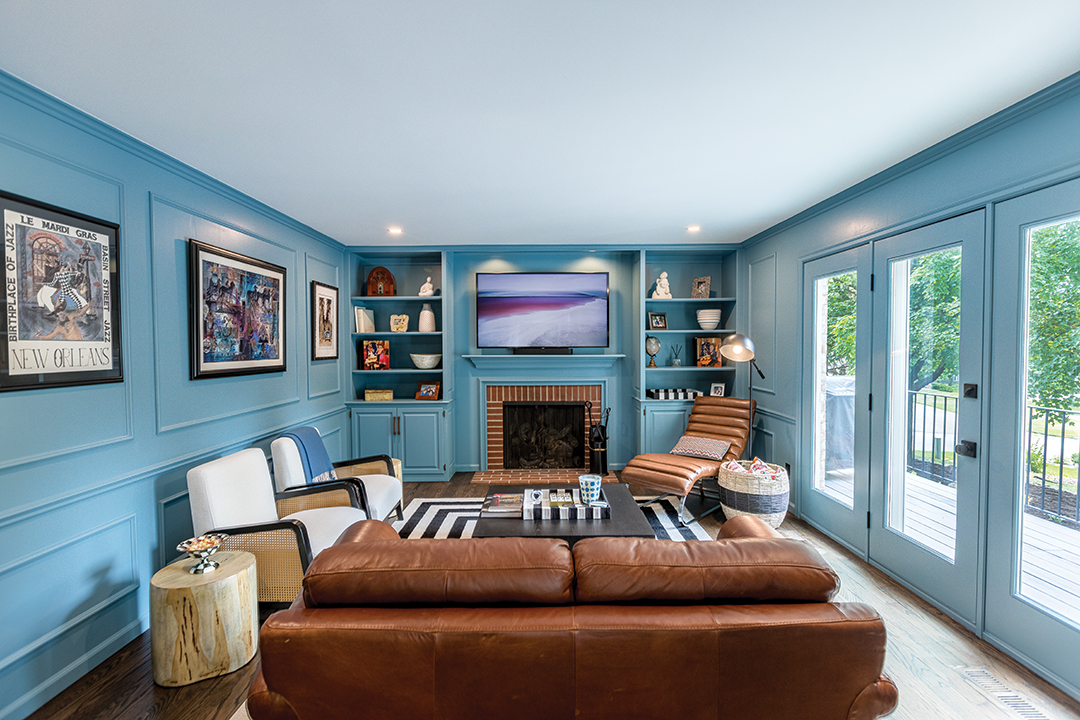 After: The remodeled den with a repaired ceiling. The wood panelling was painted blue and wainscotting remained to add texture. Warm leather accents finish the overall look. Photo: Chris Emeott