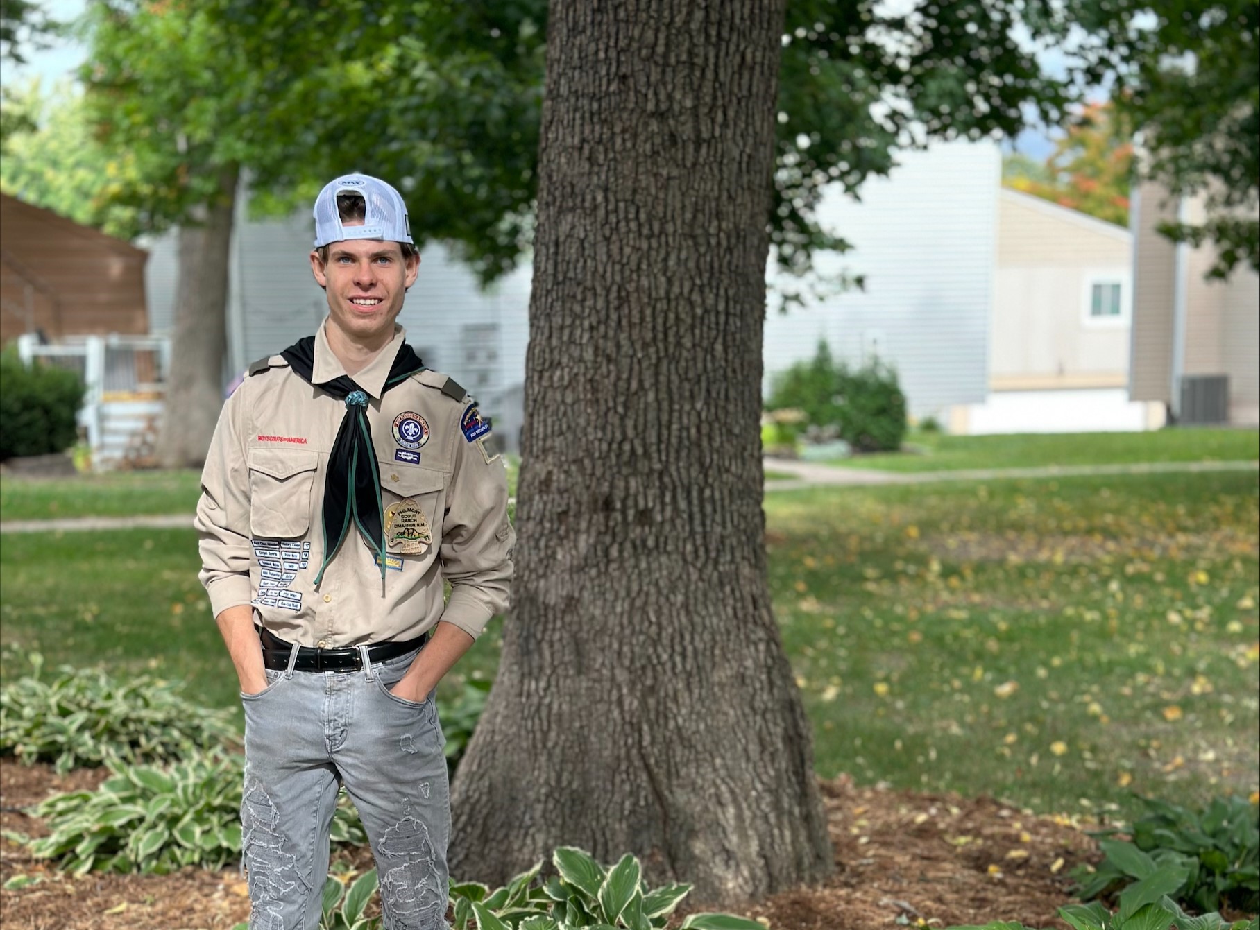 Plymouth Eagle Scout CJ Schempp stands next to one of the three benches he made as part of his Eagle Scout project. 
