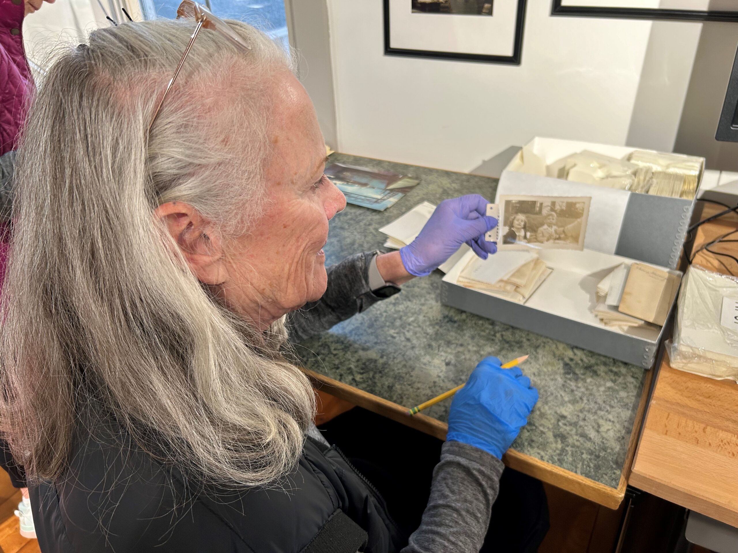 Volunteer documenting a historic photo from the archives.