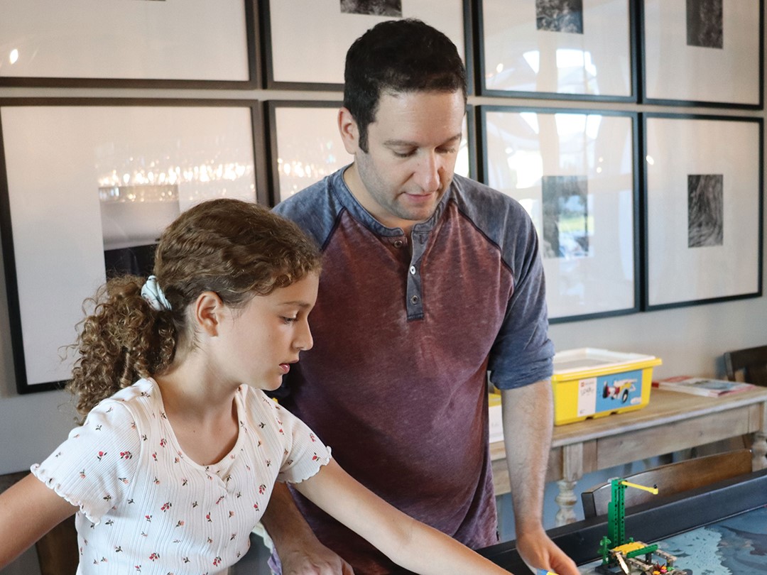 Brian and Allie Martell work on the First Lego League competition board together.