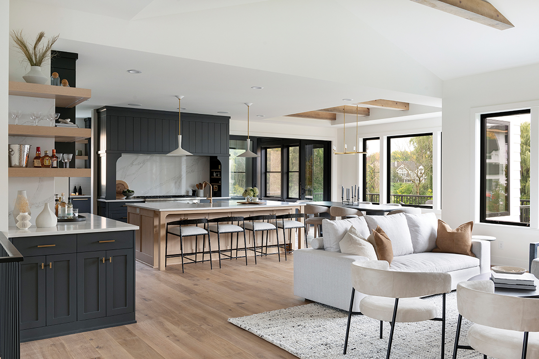 This kitchen’s range hood and built-in cabinetry are painted in Cheating Heart by Benjamin Moore. “I love how the corners of the hood tie in with the arches of the island where the seating is,” Lindsey Swanson says. 