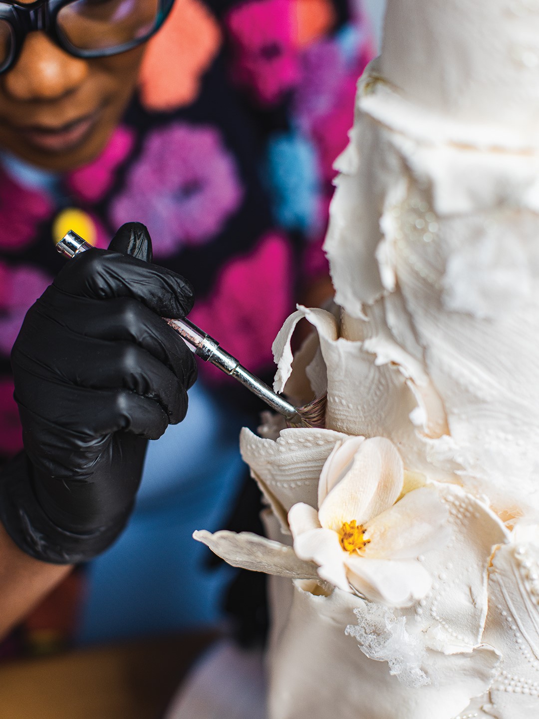 Altreisha Foster working on the details of a cake