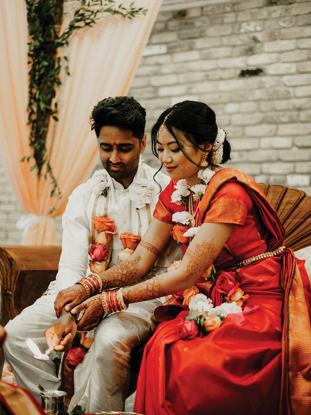 Quynh-Huong Van’s red-orange saree was chosen by her mother-in-law, and Vikram Nagarajan’s maternal aunts in India sent it to her as a gift.
