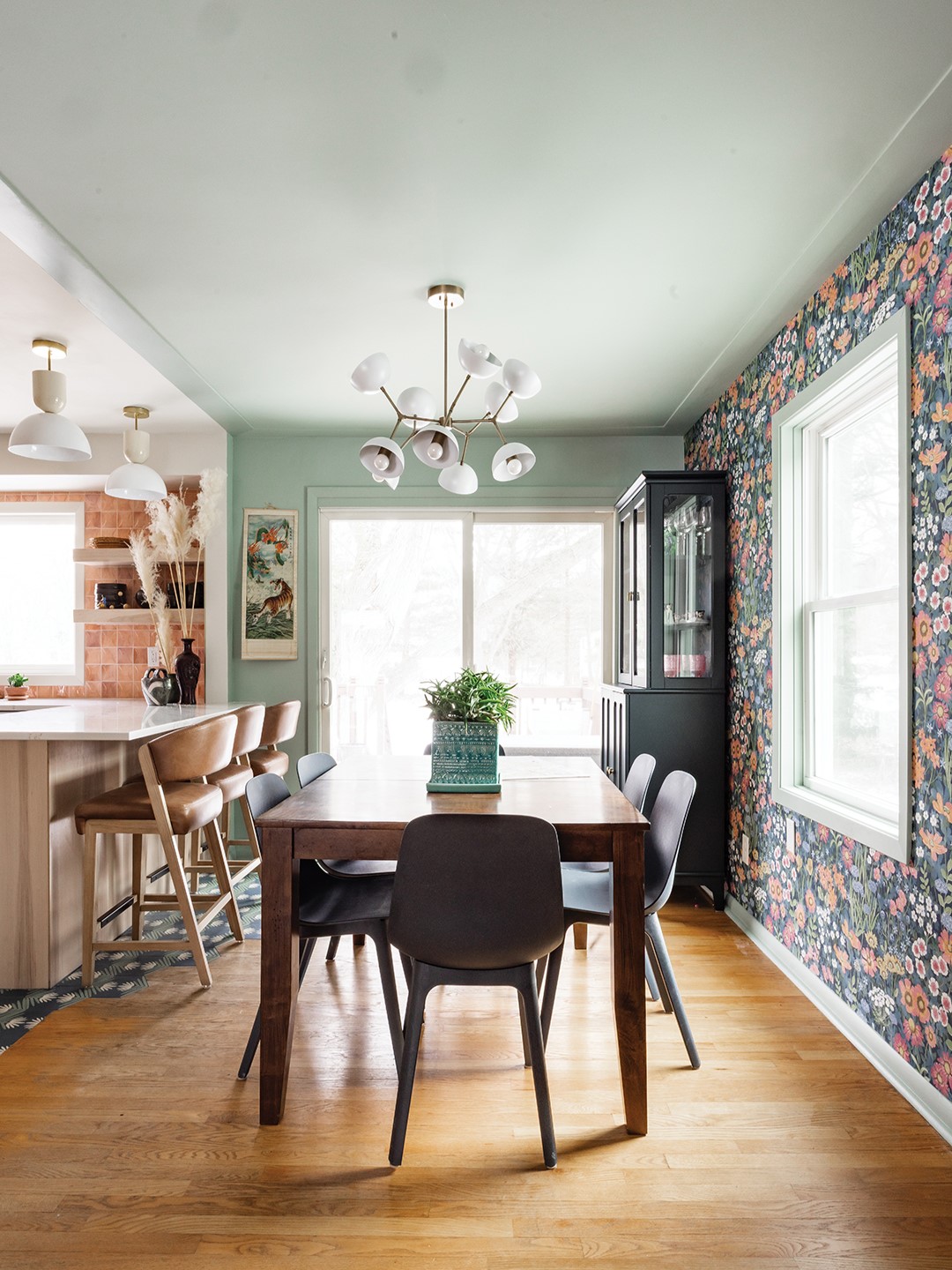 In order to create a more seamless transition and cover up where the previous kitchen cabinets once sat, Lidia Valdivia proposed extending the patterned cement tiles at an angle from the kitchen to the patio door in the dining room. As an added bonus, the first point of contact when coming in from outside is now durable tile instead of wood flooring. 