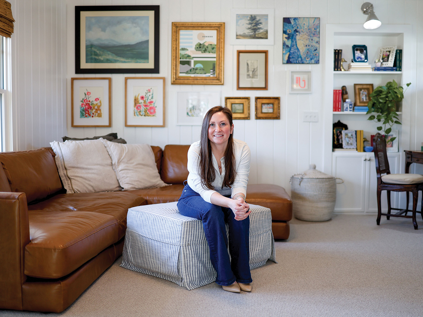 “The design inspiration came from artist Briana Auel’s piece [Concrete Jungle//Glass Ceiling]—its modern lines, vintage gold frames and palette of greens, pinks, and blues set the tone for the entire room,” Andrea Soule says. “To layer in fun, I painted the fireplace in Breakfast Room by Farrow & Ball, displayed art we’ve collected over the years and incorporated antique pieces inherited from Chase’s grandmother [Anne Hull].” Her father, Charles Soule, created the stained-glass entrance to the room, partnering with Down Home Stained Glass in Anoka.