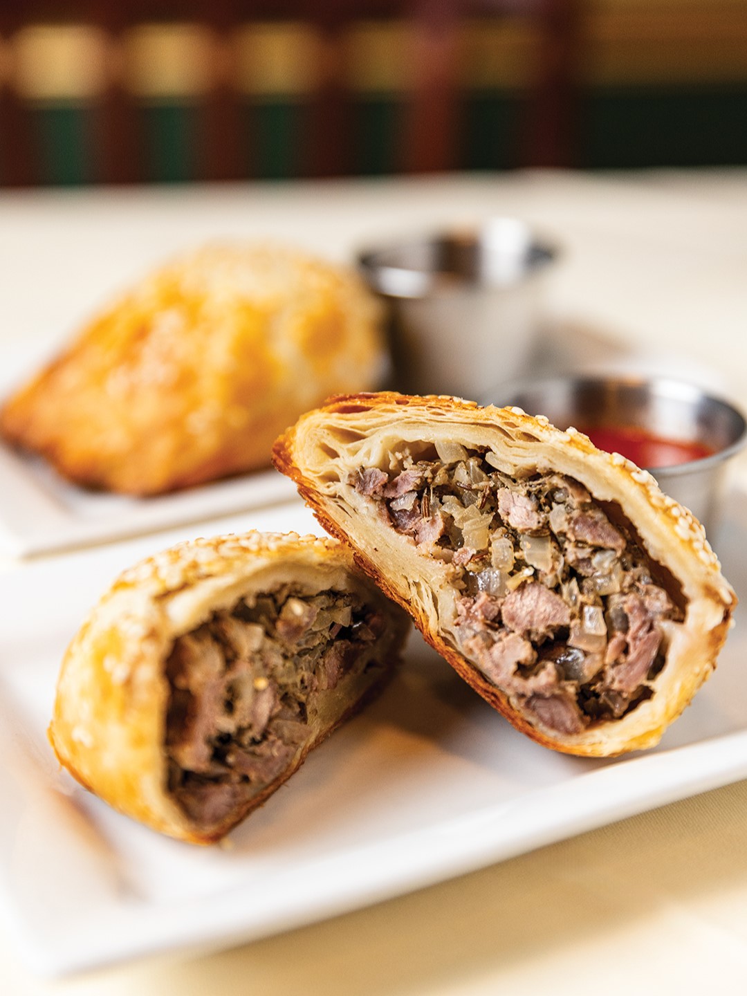 Samarkand Restaurant’s samsas feature a shell of flaky pastry dough filled with a savory mixture of ground beef and lamb, coriander, cumin and onion.  