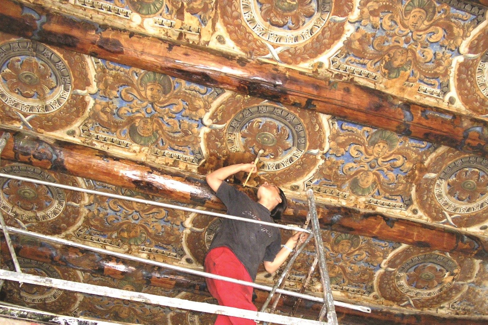 Seran Otterson restoring an Italian ceiling fresco in 2002.
